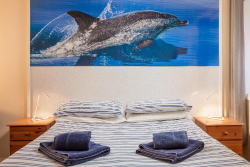 a bedroom with a bed with two towels on it at Discovery Accommodation in Whitby