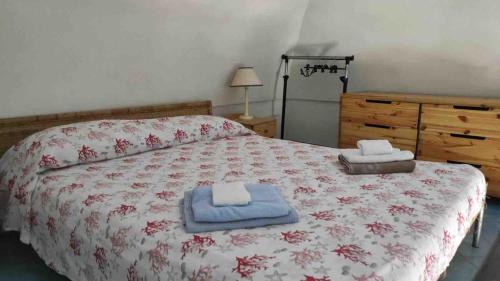a bedroom with a bed with towels on it at La Casa del Comandante in Ponza