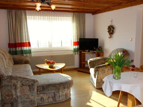 a living room with two couches and a tv at Bauernhof Kasleitner in Zell am Moos