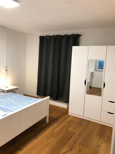 a bedroom with a bed and a black curtain at Villa Wetzel Domaso in Montemezzo
