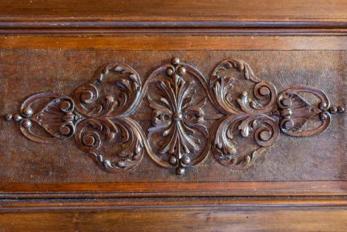 a wooden drawer with a metal design on it at beb del Musico in Montalcino