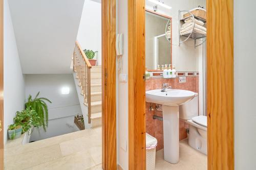 a bathroom with a sink and a toilet and a staircase at Apartamento Fernandita in Nerja