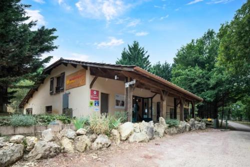 a building with a bunch of rocks in front of it at Chalets Camping Lacs d'Armagnac in Bretagne-dʼArmagnac