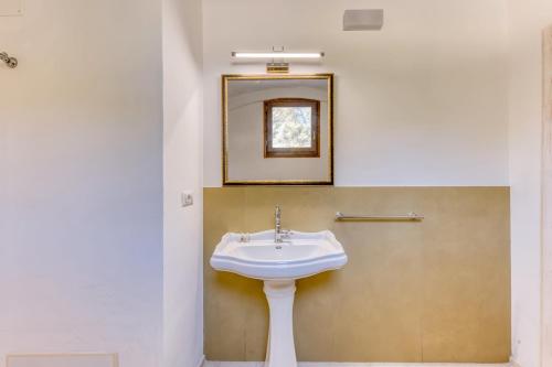 a bathroom with a sink and a mirror at Masseria Scafazzi - Salento in Presicce