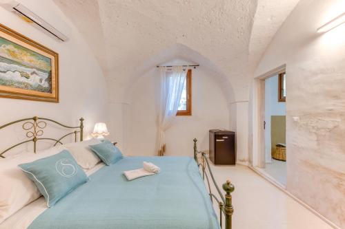 a bedroom with a bed in a white room at Masseria Scafazzi - Salento in Presicce