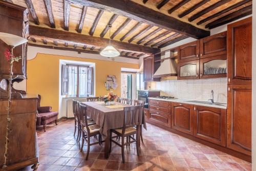 a kitchen with a table and chairs in a room at beb del Musico in Montalcino