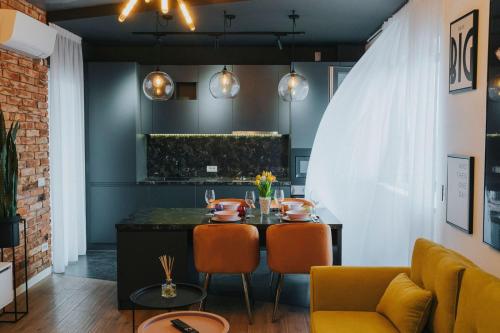 a dining room with a table and chairs at Josephine Apartment - Free Private Parking 2bedrooms in Oradea