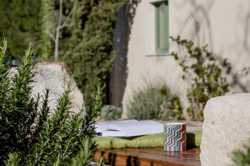 a book sitting on a table in a garden at Resort Fontes Episcopi in Aragona