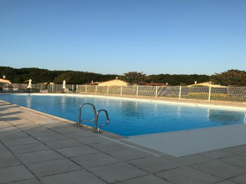 a swimming pool with a metal railing next to it at Amazing holiday home in Les Forges with terrace in Les Forges