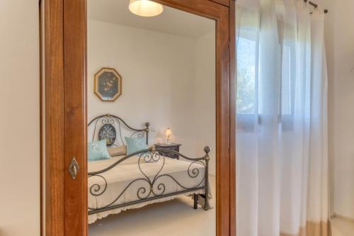 a mirror in a bedroom with a bed in it at Masseria Scafazzi - Salento in Presicce