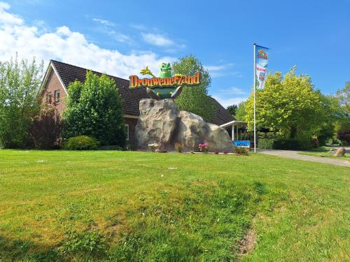 a restaurant with a sign on top of a rock at Drouwenerzand Hotel in Drouwen