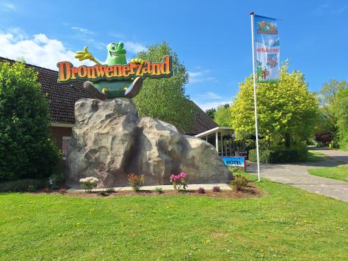 a sign for a blow up island in front of a building at Drouwenerzand Hotel in Drouwen