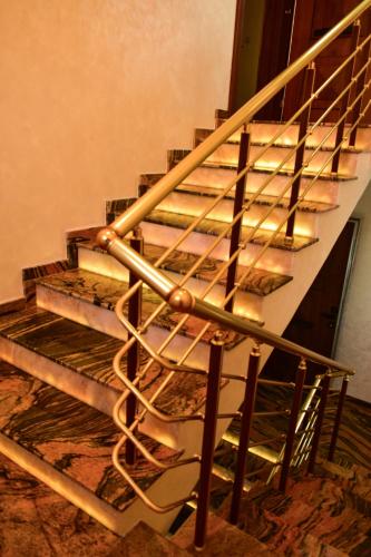 a metal spiral staircase in a room with a wall at Villa Vakanica in Petrich