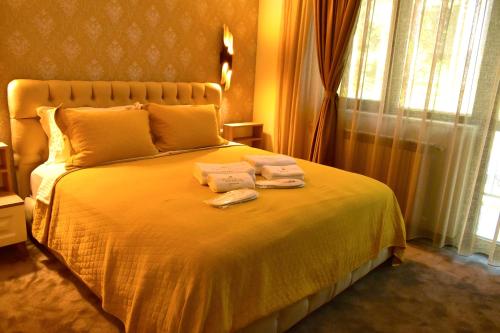 a bedroom with a bed with two towels on it at Villa Vakanica in Petrich