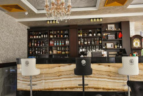 a bar with two chairs in front of a counter at Villa Vakanica in Petrich
