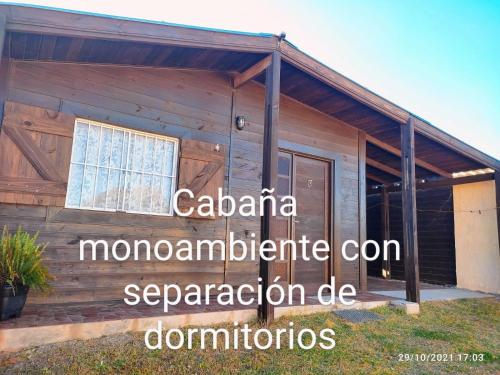 a wooden house with a sign on the side of it at Lo del Beto in San Gregorio de Polanco