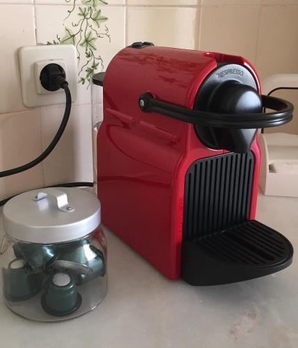 a red toaster sitting on a counter next to a coffee maker at Casa da Avenida Lisboa in Lisbon