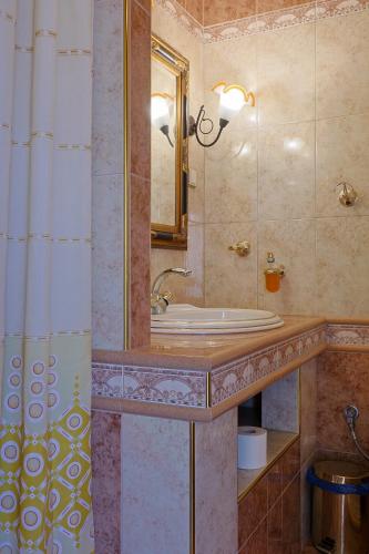 a bathroom with a sink and a mirror at Zeusplace Villa Evelin in Andromáchi
