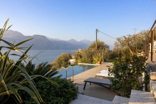 a swimming pool with a view of the water at Sunset Residence in Brenzone sul Garda