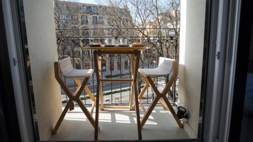 two chairs and a table on a balcony at Hotel Ciudadela Pamplona in Pamplona