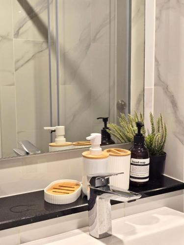 a bathroom counter with a sink and a mirror at Lisa house&home #nearcentralfestival in Hat Yai
