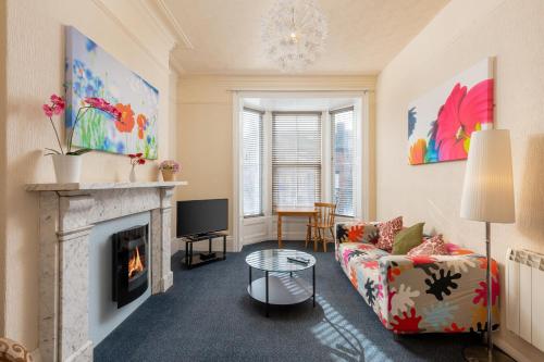 a living room with a couch and a fireplace at Beach House in Whitby