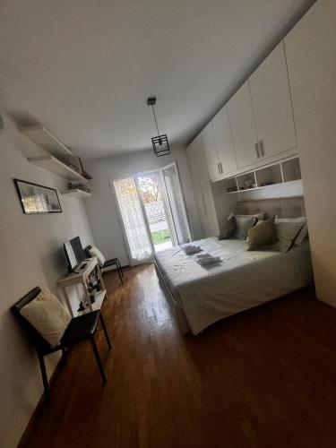 a bedroom with a bed and a large window at rachel house in Marino