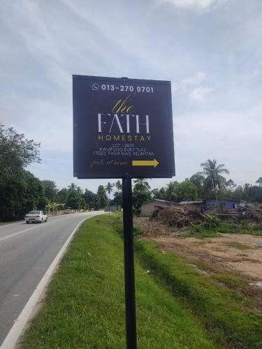 a sign on the side of a road at The Fath Homestay Pasir Mas Tanah Merah Rantau Panjang in Pasir Mas