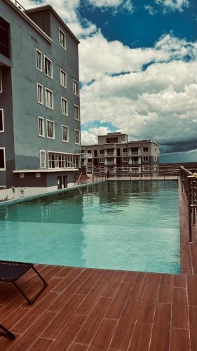 a large swimming pool in front of a building at Sabaki Green Estate in Marimbeti