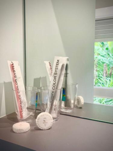 a counter with two empty glasses and a mirror at Villa Rose Marie Calme et Grands Espaces in Le François