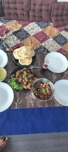 a table with plates of food on a table at Nirvana Heights Kasar Devi in Hawālbāgh