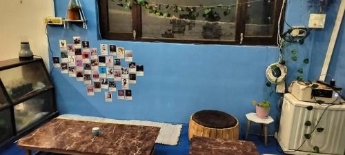 a room with a blue wall with pictures on it at Nirvana Heights Kasar Devi in Hawālbāgh