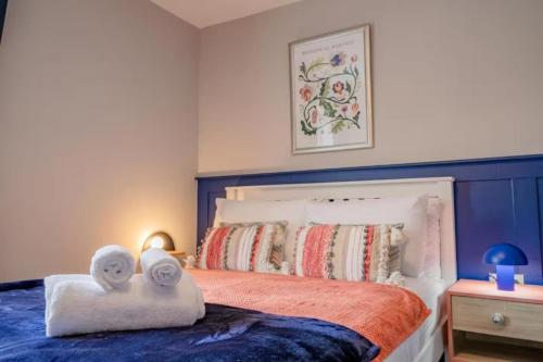 a bedroom with a bed with towels on it at Lower Chestnut House, 2 Bedroom, Central Worcester in Worcester