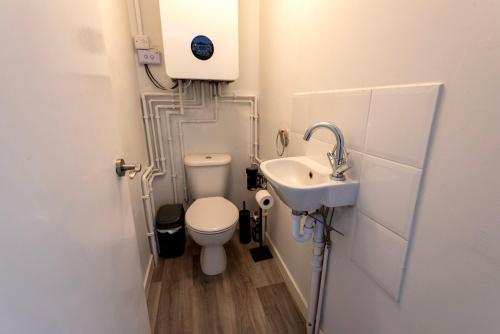 a small bathroom with a toilet and a sink at Single room in brand new 5 bedroom home BW Room 2 in Olton
