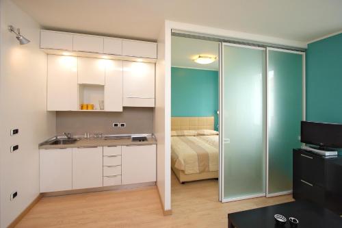 a kitchen with a sink and a bed in a room at Hotel Roma in Trieste