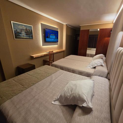 Postel nebo postele na pokoji v ubytování Hotel Gala