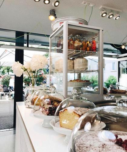 a bakery with cakes and other desserts on a counter at City Studio am Marienplatz in Stuttgart