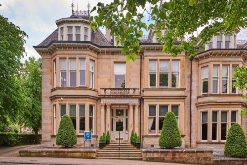 a large house with trees in front of it at One Devonshire Gardens a Hotel Du Vin in Glasgow