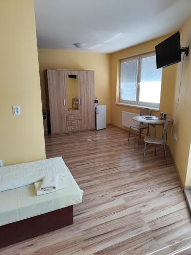 an empty room with a desk and a table at Apartmány ORAVA-EDDA in Trenčianske Teplice