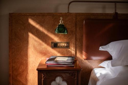 a bedroom with a bed and a table with a lamp at SIXI CANGSHAN MOUNTAINS GOLDEN SUNRISE MIRROR OF THE SKY SOUND SLEEP HOTEL DALI ANCIENT CITy in Dali
