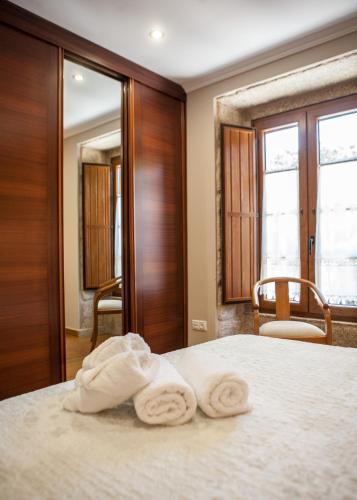a room with a bed with two towels on it at Casa De Rama in San Mamede de Carnota