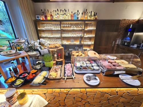 a table with many different types of food on it at Hotel Gästehaus Neubauer in Kaltenberg