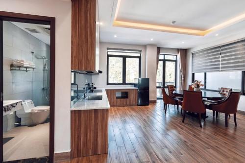 a kitchen and dining room with a table and a dining room at Cat Ba Viet Hoa Hotel & Residence - Pool & Bar in Cat Ba