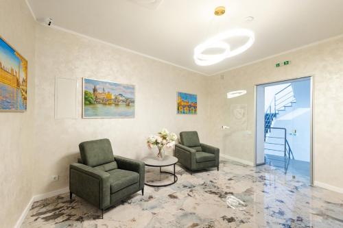 a waiting room with two chairs and a table at Nicole in Uzhhorod