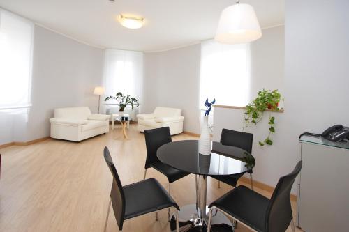 a living room with a table and chairs at Hotel Roma in Trieste