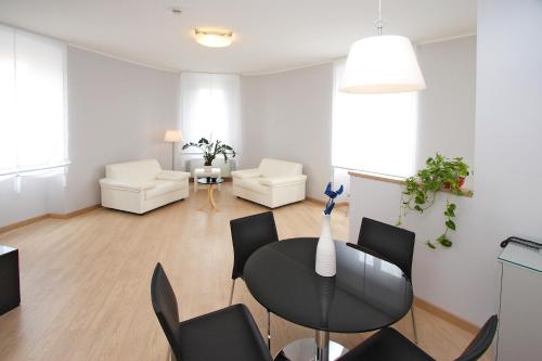 a living room with a black table and chairs at Hotel Roma in Trieste