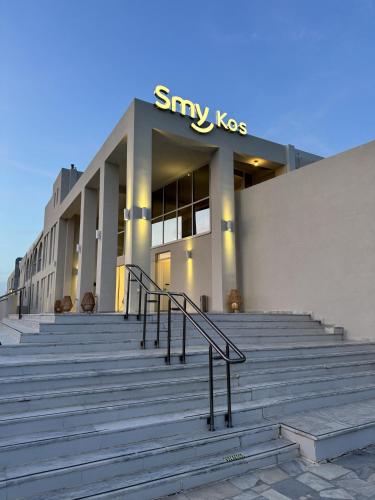 a large building with stairs in front of it at Smy Kos Beach & Splash in Mastichari