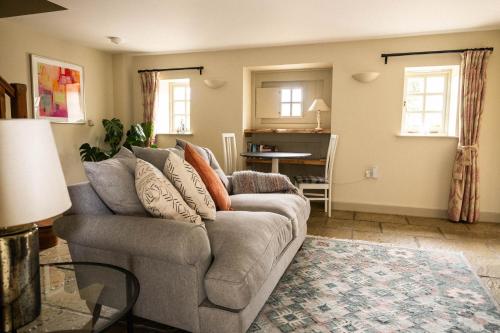 a living room with a couch and a table at The Cottages at Launceston Farm in Blandford Forum