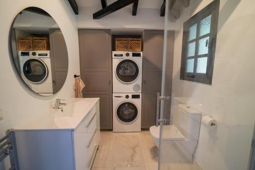 a bathroom with two washing machines and a sink at Casa El Cholo, Mijas Hideaway in Mijas