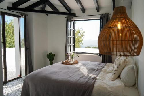 a bedroom with a bed with a large window at Casa El Cholo, Mijas Hideaway in Mijas